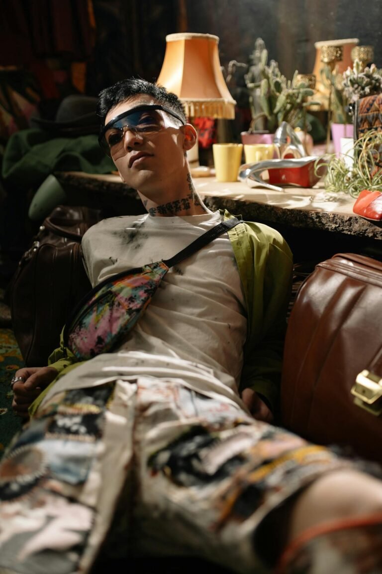 Man in Green and White Camouflage Shirt Sitting on Brown Leather Couch